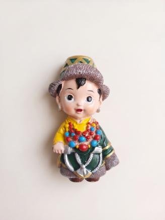 Handmade Tibetan boy fridge magnet wearing traditional Himalayan clothing