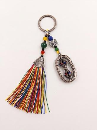 Handmade Tibetan Dorje Vajra tassel keychain featuring colorful beads and an antique-finish pendant for keys, bags, and backpacks
